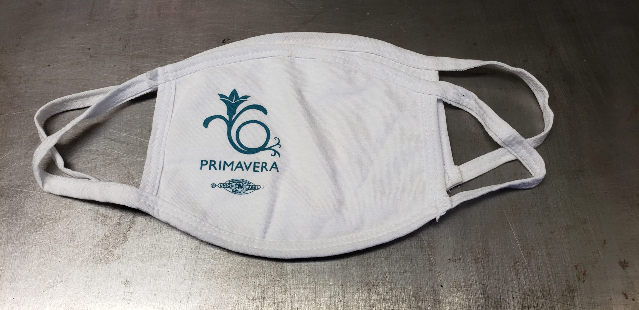 White cotton face mask with union screen printed one color logo of the Primavera.