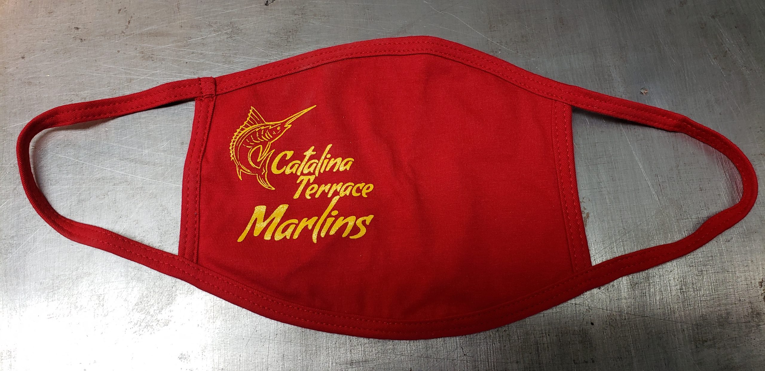 Crimson red cotton face mask with union screen printed one color design with a marlin that reads "Catalina Terrace Marlins"